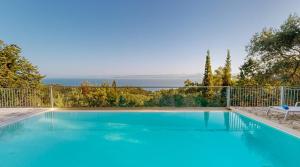 a swimming pool with a view of the water at Villa Milou in Kagkátika
