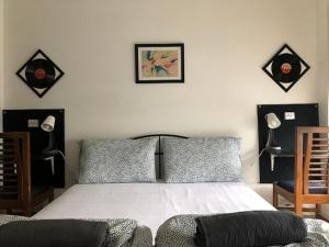 a bedroom with a bed and two chairs at Adcv in Noida