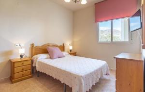 a bedroom with a bed and a dresser and a window at Beautiful Apartment In Castell De Ferro in Castell de Ferro