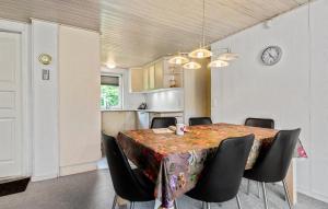 a dining room with a table and chairs and a clock at Gorgeous Home In Hemmet With Wifi in Hemmet