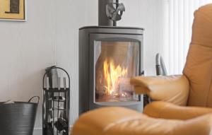 a fireplace in a living room with a fire in it at Gorgeous Home In Hemmet With Wifi in Hemmet +17 photos
