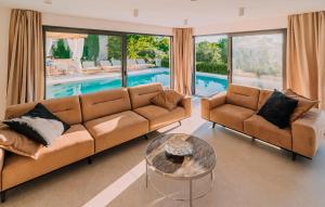 a living room with a couch and a table and a pool at Stunning Home In Privlaka With Sauna in Privlaka