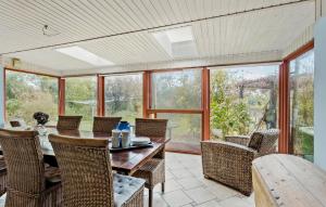 a dining room with a table and chairs and windows at 4 Bedroom Stunning Home In Humble in Humble