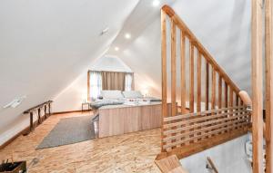 a living room with a staircase and a couch at Gorgeous Home In Gornja Voca With Sauna in Gornja Voća +34 photos
