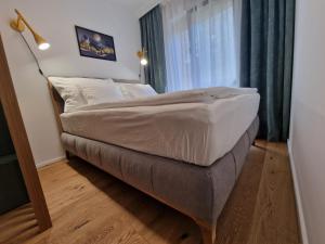 a large bed in a room with a window at Apartmán Ski & Bike Janské Lázně in Janske Lazne