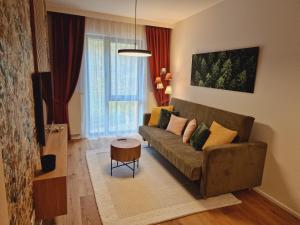 a living room with a couch and a table at Apartmán Ski & Bike Janské Lázně in Janske Lazne