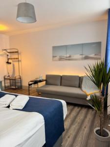 a living room with two beds and a couch at Camden Luxury Studio Flats and En-Suit Rooms in London