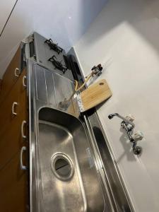 ein Metallwaschbecken in einer Küche mit Arbeitsplatte in der Unterkunft 京橋駅徒歩10分圏内隠れ宿京橋 in Osaka + 32 Fotos