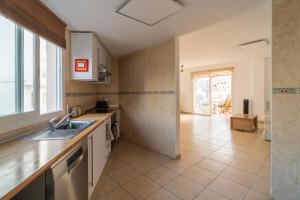 a kitchen with a sink and a counter at Apartment happy place mit Meerblick in Alcalá