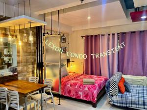 a room with a bed and a table and a dining room at Lexon- Ethan in Baguio