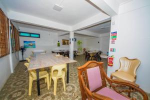 a dining room with a table and chairs at Gravier Holidays A day in paradise in Saint Francois