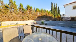 a patio with a table and chairs on a balcony at La Magenta Apartments in Pyla