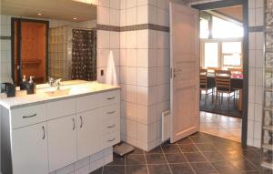 a bathroom with a sink and a mirror at Holiday Home Møllevangen Oksbøl X in Ovtrup