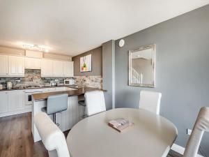 a kitchen with a white table and chairs in a room at Cottage 5 - Uk38221 in Ashby cum Fenby