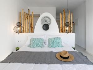 a bedroom with a bed with a hat on it at Naxos Earth Suites in Mikri Vigla