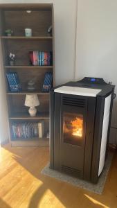 a fireplace in a living room with a book shelf at Vito apartments in Jajce