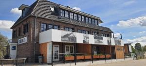 a large brick building with a sign on it at Sientjes Boetiekhotel in Kerkdriel