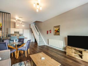 a living room with a television and a dining room at Cottage 9 - Uk38220 in Ashby cum Fenby