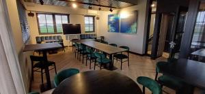 a room with tables and chairs and a flat screen tv at Sientjes Boetiekhotel in Kerkdriel