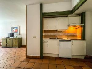a kitchen with white cabinets and a sink at Dornajo Dream By BlueTTravel in Sierra Nevada