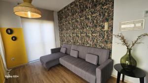 a living room with a couch and a vase at Apartamento Yellow Garrucha in Garrucha