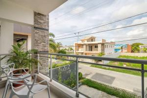 a balcony with a chair and a view of a street at Villa Vintage. in Boca Chica +51 photos