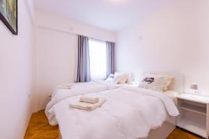 Ένα ή περισσότερα κρεβάτια σε δωμάτιο στο KRIK Apartments