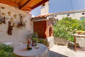 a small table in front of a house at Apartment Carmen in Veli Lošinj