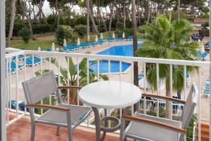 ein Balkon mit Tisch und Stühlen und ein Pool in der Unterkunft Hotel Pabisa Sofia in Playa de Palma + 8 Fotos