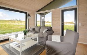 a living room with a couch and chairs and windows at Three-Bedroom Holiday Home In Grenaa in Grenå