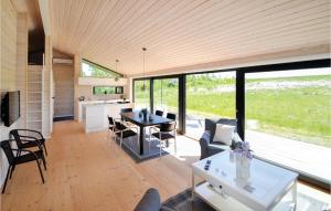 a kitchen and living room with a table and chairs at Three-Bedroom Holiday Home In Grenaa in Grenå