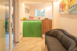 a living room with a couch and a green counter at Blue Lake Residence - Bardolino in Bardolino