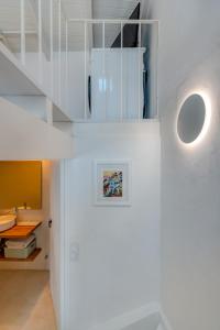 a white room with a staircase and a table at Casa Pescador in Alvor in Alvor