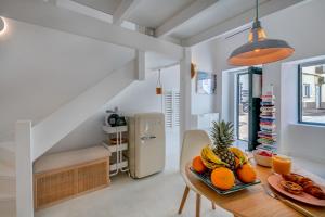 a dining room with a table with fruit on it at Casa Pescador in Alvor in Alvor +20 photos