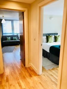 a bedroom with a bed and a living room at 20 minute to central London beautiful apartment in London