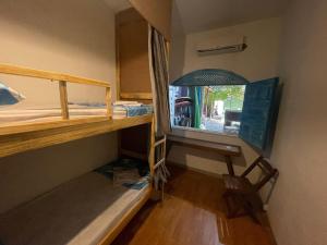 a dorm room with a desk and bunk beds at HOSTEL ARACAJU Sequência Surf Paradise POUSADA in Aracaju