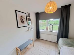 a bedroom with a window and a bench in front of it at Vakantiehuis Heinkenszand VP002 met privésauna in Heinkensand +19 photos