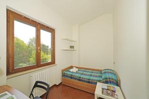 Giường trong phòng chung tại Villetta Gro - Gardagate