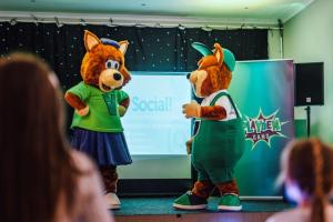 two mascots standing on a stage next to each other at Limetree Lodge 2 at Thurston Manor Leisure Park in Dunbar