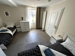 HelfantHelfant Luxembourg Deluxe Double Room 1的一间卧室，配有两张床、一个梳妆台和一扇窗户