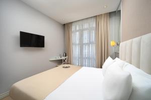Postel nebo postele na pokoji v ubytování Ess Hotel