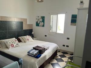 ein Schlafzimmer mit einem Bett mit Handtüchern und einem Fenster in der Unterkunft NATURAL CONFITAL BEACH in Las Palmas de Gran Canaria
