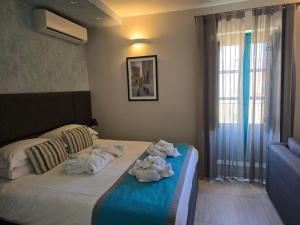 Postel nebo postele na pokoji v ubytování D Townhouse Boutique Suites