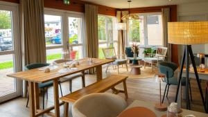 a dining room with tables and chairs and windows at Hôtel Nell Axelle - Maison Tassoni in Saint-Marcel +76 photos