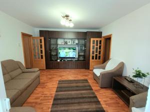 ein Wohnzimmer mit zwei Sofas und einem Fernseher in der Unterkunft Apartament 2 Camere, Etaj 1 in Buzău