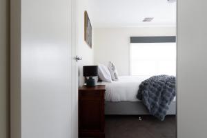 a bedroom with a bed and a window at The Riverside Hideaway - A Tranquil Escape in Inveresk