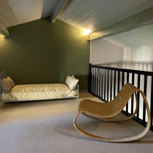 a room with a bed and a chair in it at Château Doré les Tours - Appartement Loup in Montfaucon