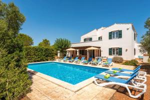 a villa with a swimming pool and lounge chairs at Villa Biniparrell by Villa Plus in Biniparrell