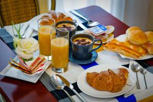 a table with breakfast foods and drinks on it at Hotel Boccascena in Genoa