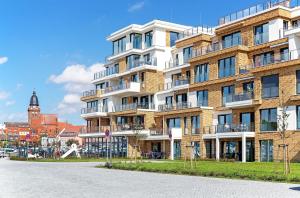 a large brick building on the side of a street at Atlantica - Apartment in der Hafenresidenz mit Wellness & Müritzblick in Waren